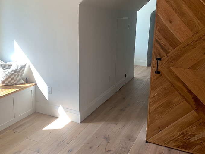 Contemporary bedroom with Rustic NEUE Vltava character grade engineered European white oak wood floors